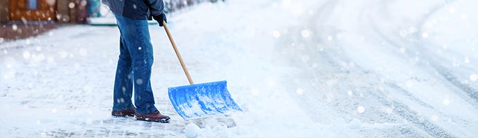 shoveling snow off the sidewalk